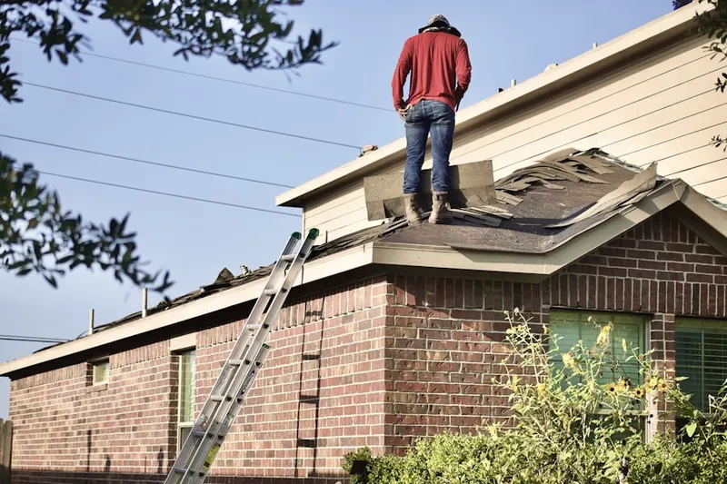 Professional roofer working on a residential roof in Mary Ellen